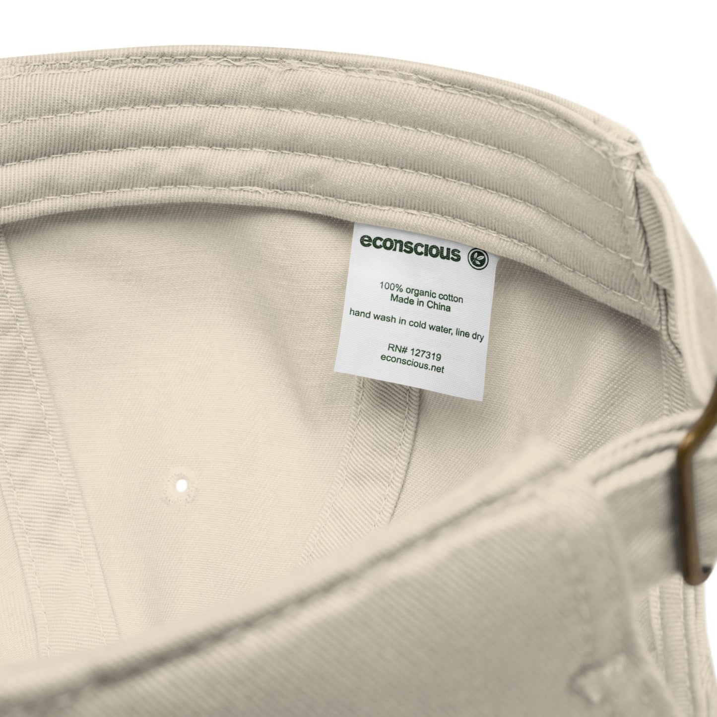 Close-up of the Desert Dust Aether Peak cap with an Econscious label on a white background