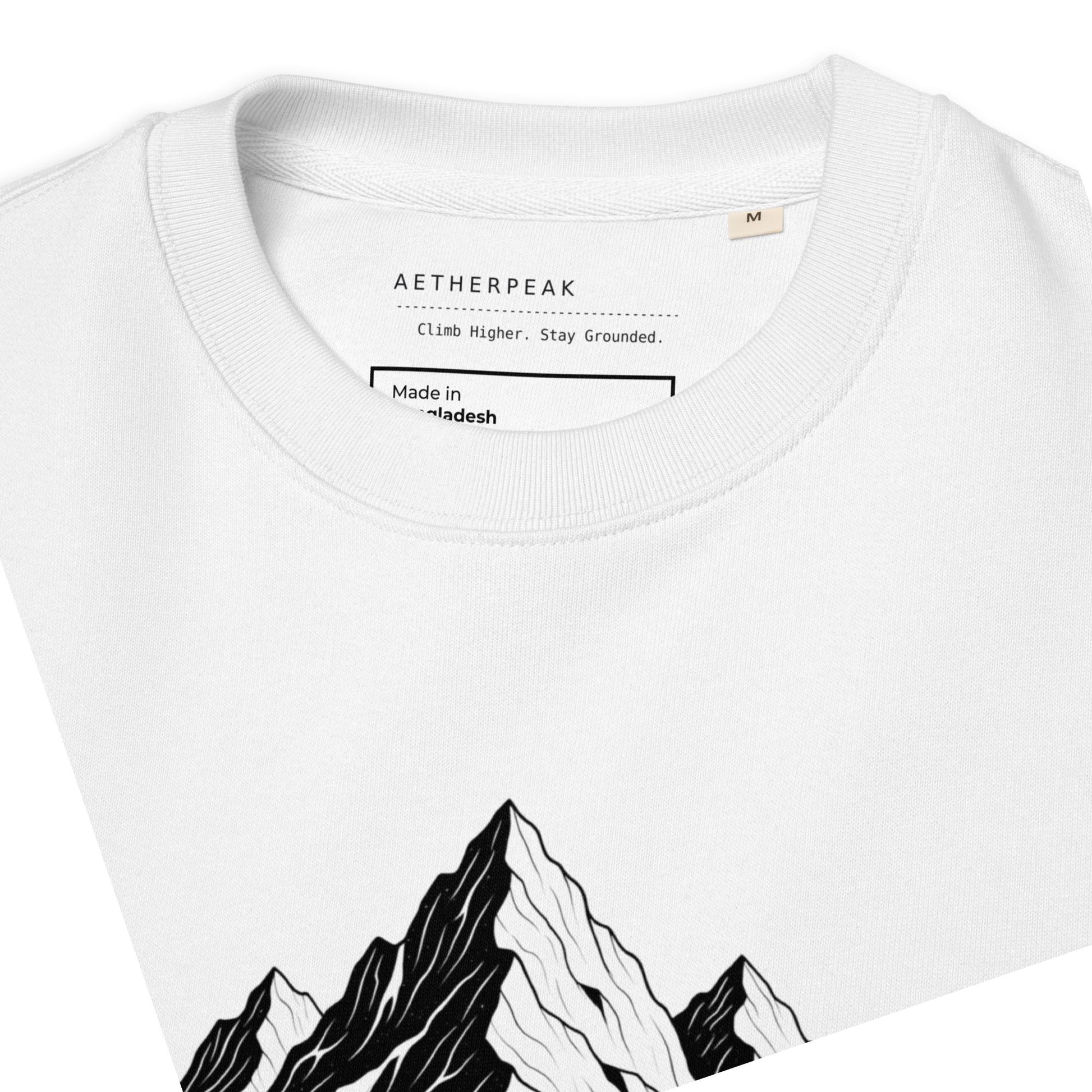White sweatshirt with the Mountain Roots design and 'Aetherpeak' branding on inside label.
