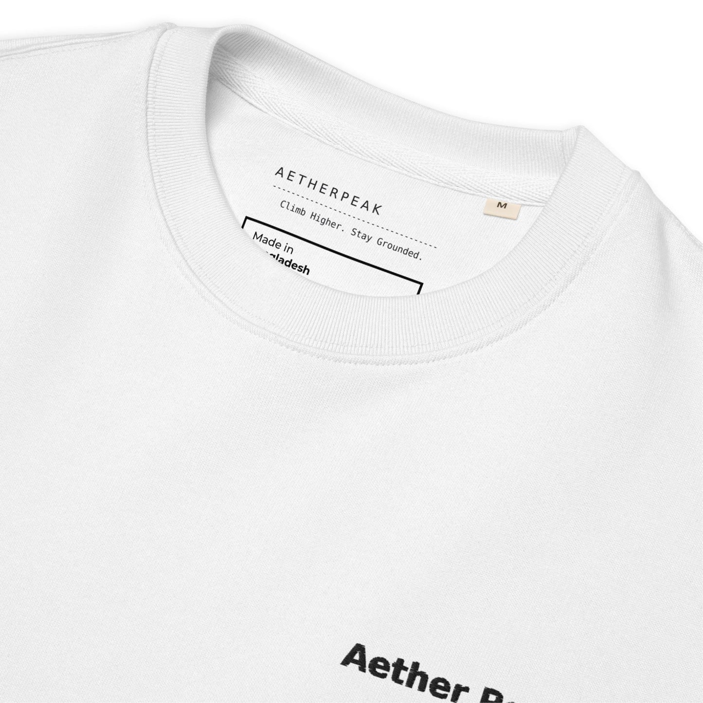 Close-up of a white t-shirt with 'Aetherpeak' branding and text on the collar.