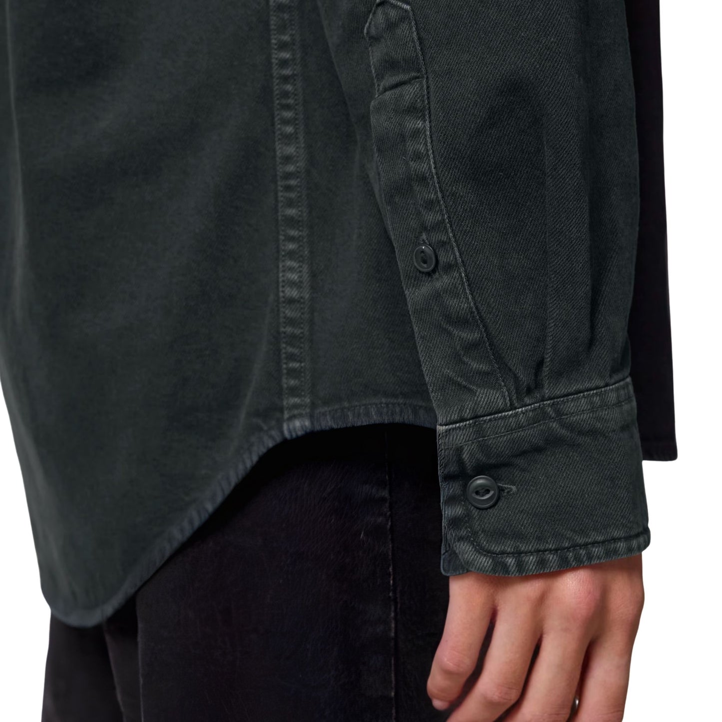 Close-up of the black Aether Peak  overshirt, worn by a model, showing the sleeve on a white background