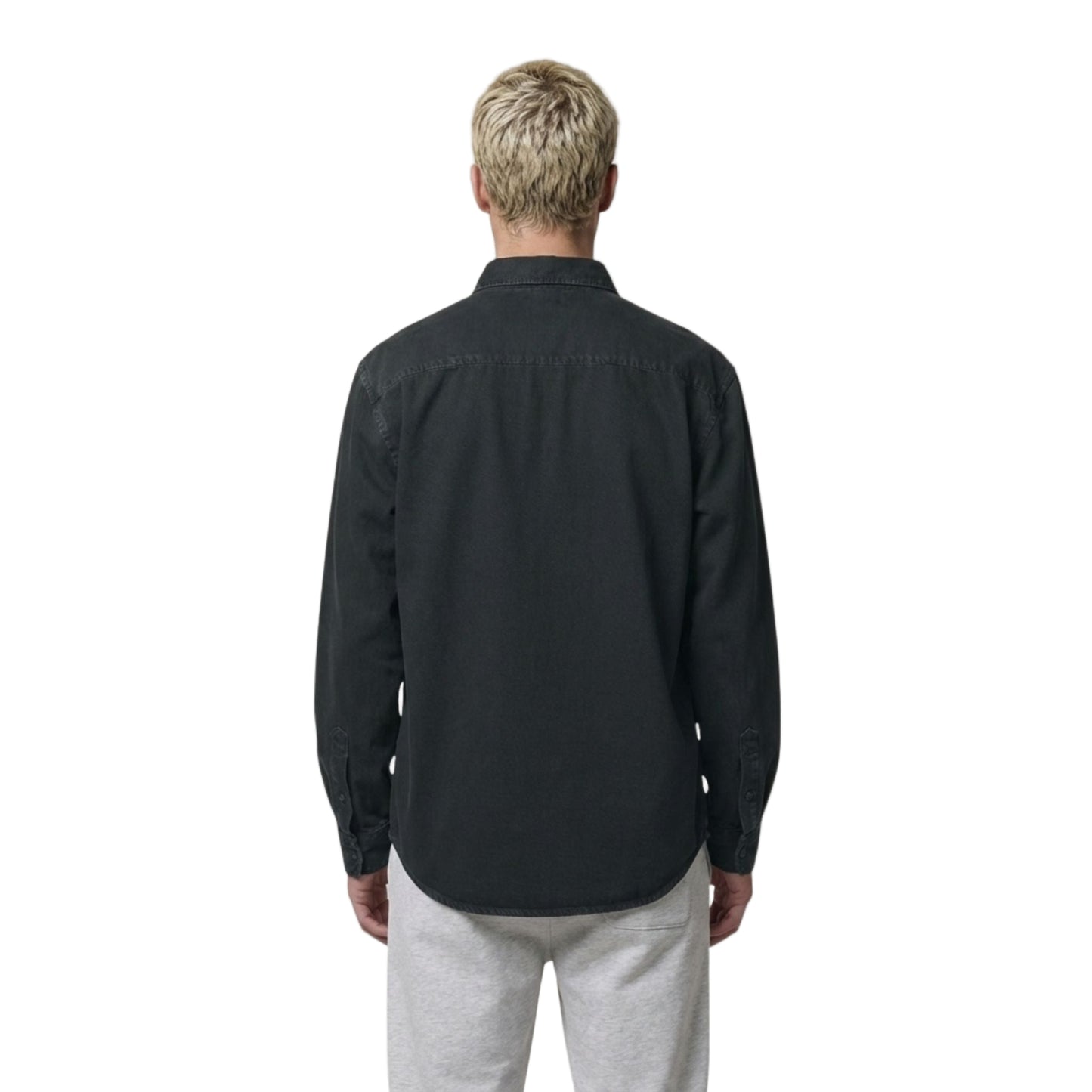 Man wearing the black Aether Peak long-sleeve overshirt on a white background
