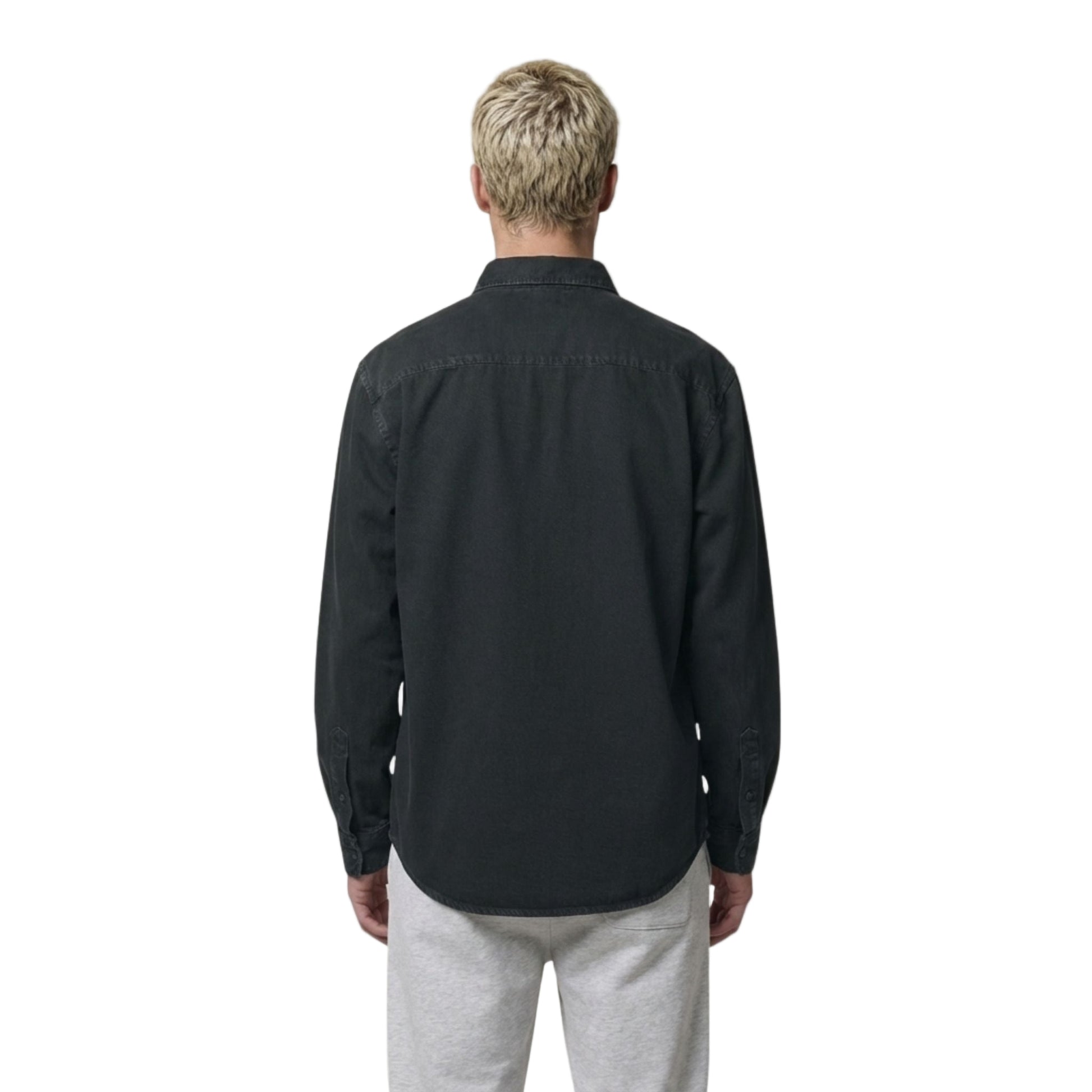 Man wearing the black Aether Peak long-sleeve overshirt on a white background