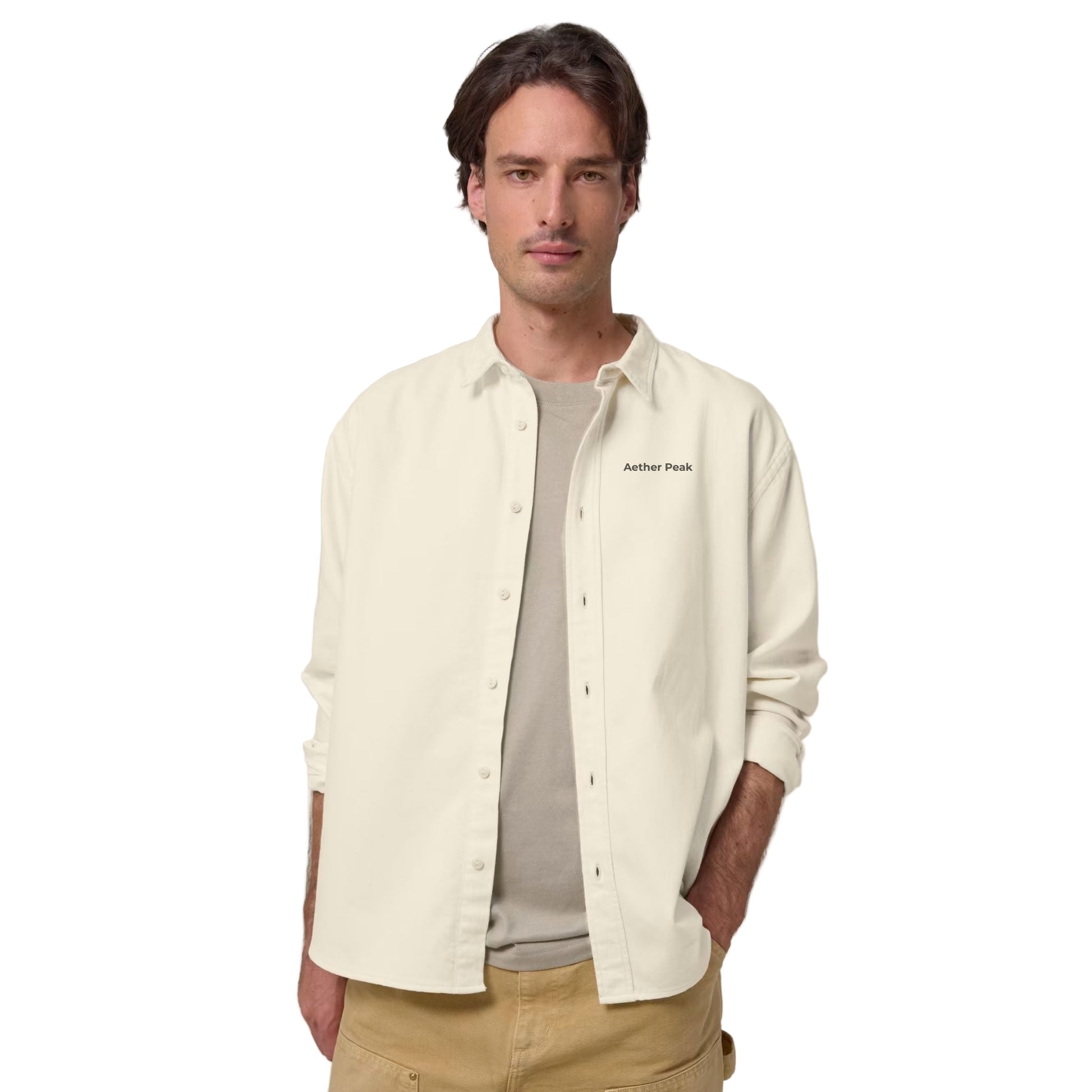 A man wearing the Desert Dust  overshirt with 'Aether Peak ' branding on a white background