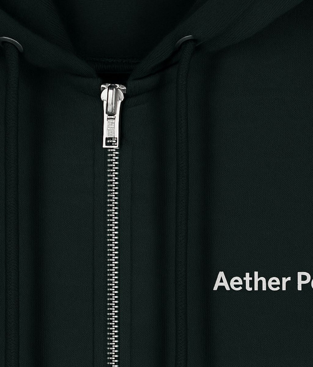 Close-up of a black Aether Peak organic zipped hoodie, showing the metal zipper, drawstrings, and partially visible white “Aether Peak” logo on the left chest.
