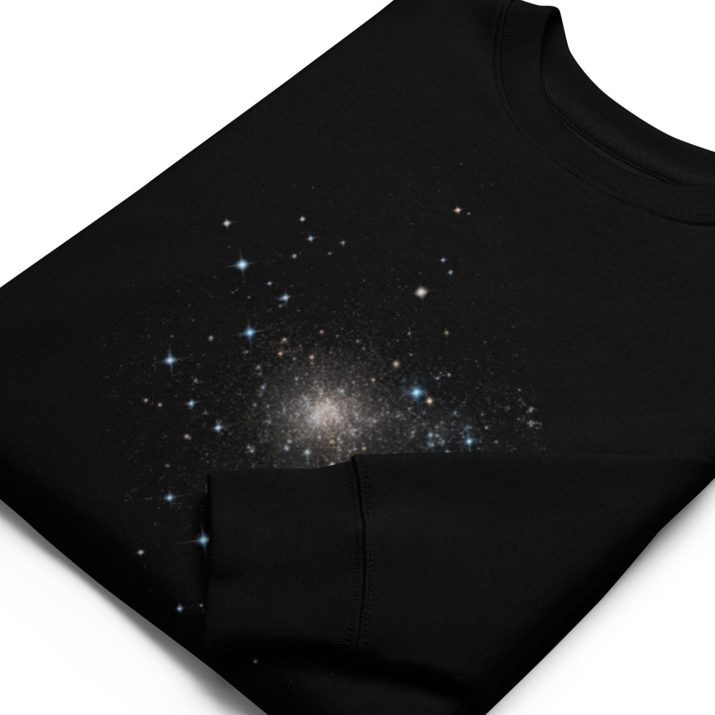 Close-up view of the Aether Peak, The Starry Sky organic cotton sweatshirt in black, folded up laying flat against a white background.
