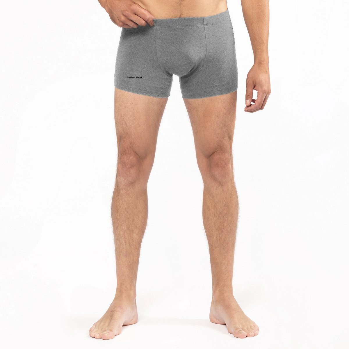 Male model wearing Heather Grey Aether Peak boxer briefs on a white studio background.